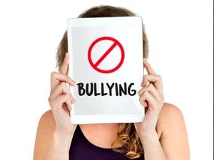 woman holding a No Bullying sign